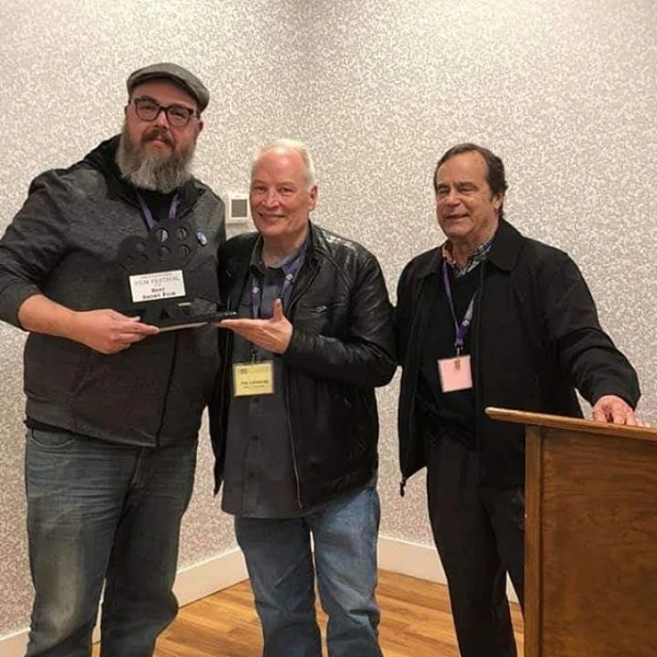 Michael Charron receiving the Best Short Film award with Joe R. Lansdale at the Nacogdoches Film Festival
